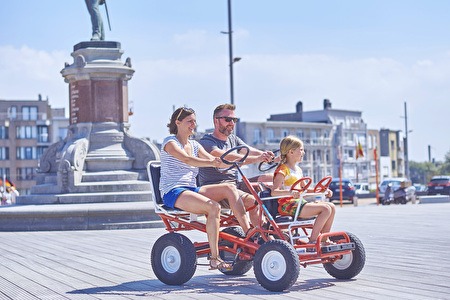 Three people on a typical go-cart or 'billenkar'